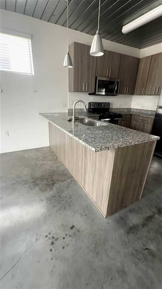 Clean kitchen island and granite counters after a Texas Nova Cleaning service in Houston